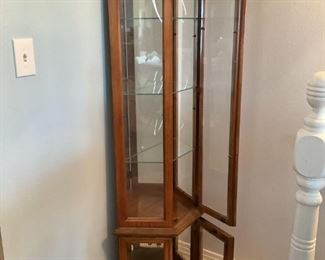 Curio Display Cabinet
Medium dark wood Curio Display Cabinet. H70" x W24" x D11". Has two (2) doors & three (3) glass shelves. Has two (2) lights w/cords. Some scrapes & lower right section scuffs on back. Good condition other than noted.