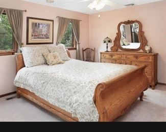 Carved Oak Sleigh Bed and carved long dresser with mirror