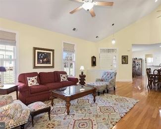 Living Room includes new matching Pier 1 furniture and carpet; comfortable red couch and antique tables.
