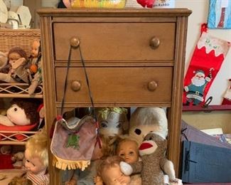 cute little small 2 drawer table and look at all these vintage dolls!
