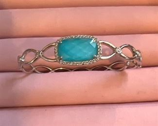 18k white gold bracelet with 34 diamonds surrounding a turquoise gemstone with 4 add’l diamonds on band