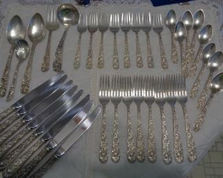 S. Kirk and Sons Repousse pattern sterling silver four-piece set for eight, plus five serving pieces.  