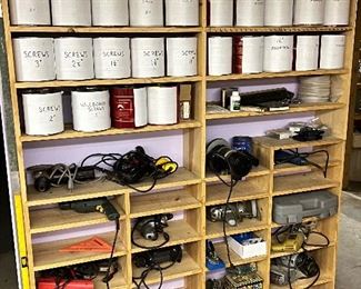 Cans full of wood screws and hand tools. 