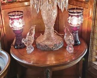 Lazy Susan style side table and bookshelf. Crystal lamp with mushroom shade. Red side lamps and glass dub
