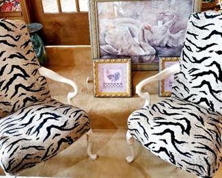Wooden arm chairs with zebra upholstery. We have two of these. Both with significant paint scratching on the feet. Priced separately
