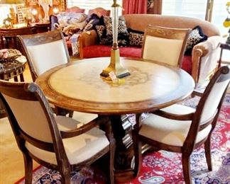 Hand-painted round wooden dining room table and chairs. Sold as a set