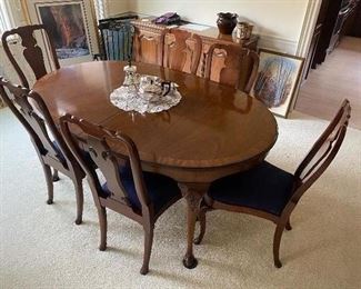 Dining table with eight chairs, three additional leaves, and pads.