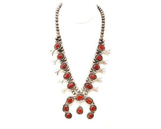 #600 • Vintage Navajo Squash Blossom Necklace 20" Red Coral Marked Sterling Signed: Beautiful and rare vintage pre-owned red coral squash blossom necklace that measures 20" in length from hook to other end and weighs 110 grams.  The necklace is marked "sterling" and also has the artist signed "R" for possibly Ray Fierro Navajo Native American.  The Naja measures from the widest point 2-3/4 inches and the height of the Naja approximately 2-1/4 inch.
