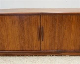 1008	DYRLUND DANSIH MODERN ROSEWOOD CREDENZA HAS A COUPLE OF VENEER BUBBLES ON THE TOP SURFACE, HAS TAMBOUR DOORS & INTERIOR DRAWERS. 75 IN W, 19 IN DEEP, 29 IN H 
