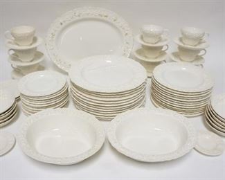 1232	72 PC WEDGWOOD EMBOSSED QUEENSWARE IVORY DINNERWARE, SOME STAINING PLATTER IS 14 1/2 IN 
