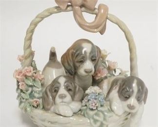 1235	LLADRO BASKET OF PUPPIES, CHIP ON ONE OF THE FLOWER PETALS. 5 1/2 IN H 
