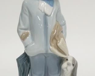 1238	LLADRA BOY IN WINTER CLOTHES W/ PUPPY 8 IN H 
