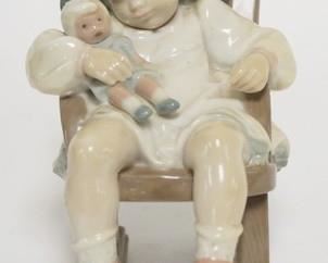 1239	LLADRO GIRL W/ DOLL IN ROCKING CHAIR 5 IN H 
