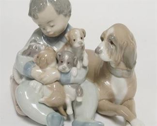 1243	LLADRO BOY W/ PUPPIES IN HIS ARMS 5 IN H 
