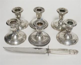 1315	3 PAIRS OF WEIGHTED STERLING SILVER CANDLESTICKS, 2 PAIRS ARE MATCHED, SOME TWISTIN IN THE STEMS, INCLUDES A KNIFE W/STERLING SILVER HANDLE, CANDLESTICKS 3 1/4 IN HIGH
