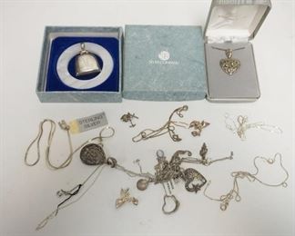 1319	LOT W/STERLING SILVER JEWELRY, INCLUDES STERLING HEART PENDANT FROM LORD & TAYLOR IN BOX, WEB UNMARKED TEETHING RING/RATTLE IN BOX, MONOGRAMMED M. SOME OF THE JEWELRY IS TANGLED
