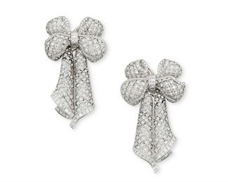 1010
A Pair Of Diamond Bow Ear Pendants
Platinum
Designed as open work articulated lace entirely accented by round, square and baguette-cut diamonds totaling approximately 6cts. and graded F-G color and VS clarity, with clip backs
2.25" L x 1.25" W
37.5 grams
2 pieces
Estimate: $4,000 - $6,000