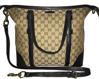 Gucci handbag that stretches to 16 inch width; logo fabric with black leather trim