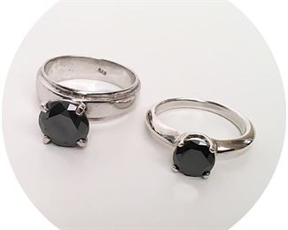 Both African black diamond rings are .925 silver. We do not have details on the larger ring. The smaller is 1.53 carats, and the color is Fancy Black/Opaque.