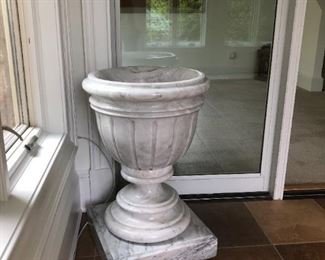 $250     
LARGE CLASSIC VINTAGE ITALIAN WHITE CARRARA MARBLE URN/PLANTER
 
Exquisitely handcrafted and hand carved Carrara White marble Planter/Plant stand.  It is made of solid Italian White Carrara marble, with a natural white field, heavy grey veining and a silken smooth finish.
It has the classic styling of traditional urn design with an extended foot heavily carved with 4 rings, vertical carving throughout the body and an elegantly simple ringed mouth.  A versatile piece that adds a timeless, classical elegance to any setting.

 
DETAILS:
OVERALL DIMENSIONS: 29.5H X 19.5W -
FOOT: 4H X 17.5W 
 
Condition: An extremely heavy piece.  This piece is an original vintage Italian urn and in very good condition to be expected with a piece of this age. Please refer to photo's for a more detailed look at condition.  We make every attempt to list and photograph any defects or signs of wear that are significant to this sale. 