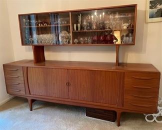 $3000   DANISH TEAK SIDEBOARD W/CHINA HUTCH BY JOHANNES ANDERSON FOR ULDUM MØBELFABRICK

 WHY WE LOVE IT:

No need to ask - Look at this beauty!

DETAILS + DIMENSIONS:

Low sideboard/credenza in teak
Designed by MAA. Johannes Andersen
Produced by Uldum Møbler Denmark in the 1950s
Close description
Country of Manufacture Denmark
Attribution Marks This piece is a well-known design that is well documented in general design literature
Style Vintage, Mid-Century, Scandinavian Modern, Minimalist

CREDENZA:

Width 94 in L x 20 in D x 33 in H
HUTCH: 

72 in L x 12  in D x 32 in H
 

CONDITION: This original vintage item has no defects, but it may show minor traces of wear commensurate of light use and age.  Please refer to photo's for a more detailed look at condition.  We make every attempt to list and photograph any defects or signs of wear that are significant to this sale. 