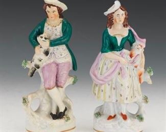 Two Staffordshire Figures of Man and Woman with Dogs