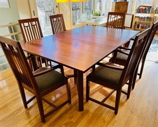 Thomas Moser cherry dining set with Knoll loden green mohair upholstered seats.  Each piece of this dining set is signed and dated 2001.  There are two 22” leaves with individual carrying cases and six arm chairs.  Table without leaves is a 52” square