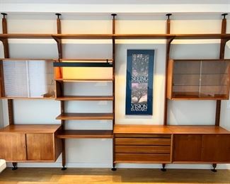 Stunning Danish Modern Poul Cadovius for Cado tension pole four bay wall unit.  This piece is capable of being used as a room divider as there are stay pin holes on the front and back of the tension poles.  As pictured, 130”W x 94”T x 18”D