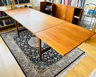 Unique Danish Modern Teak Drop Leaf Dining Table.  Goes from 47” long to 94” when the two 23 1/2” leaves are fully extended.  Overall width is 31 1/2”.