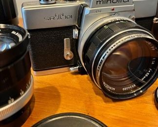 Vintage Minolta SRT 101 35mm camera with three additional lenses