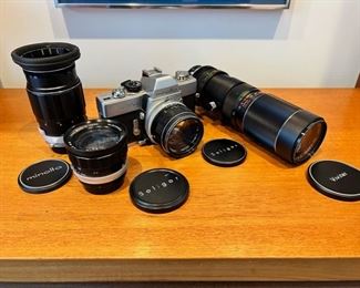 Vintage Minolta SRT 101 35mm camera with three additional lenses