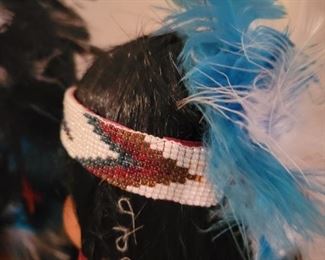 Locally made Porcelain Handmade Native American dolls on stands.