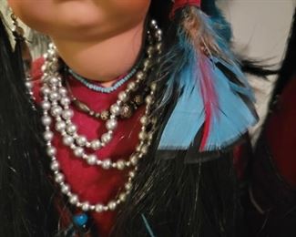 Locally made Porcelain Handmade Native American dolls on stands.