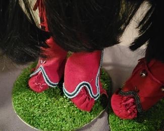 Locally made Porcelain Handmade Native American dolls on stands.