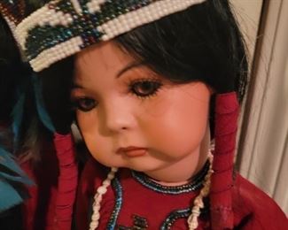 Locally made Porcelain Handmade Native American dolls on stands.