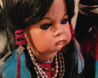 Locally made Porcelain Handmade Native American dolls on stands.