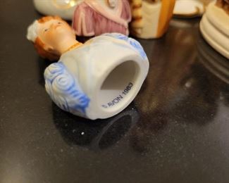 Porcelain figures including "Gorham Lady Taking a Trip" and Avon ladies thimbles, American Remembers Family Reads aloud