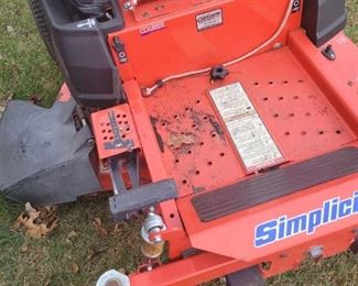 42 inch cut Simplicity zero turn mower with Briggs and Stratton motor, need a tune-up and new blades plus has some damage to plastic to right side plastic on cup holder