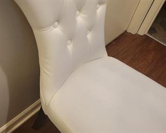 Faux leather armless chair with some discoloration on fabric