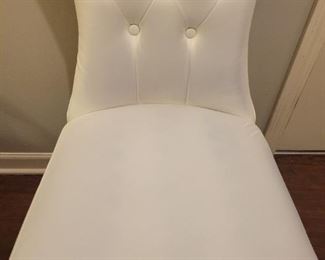 Faux leather armless chair with some discoloration on fabric