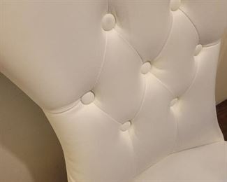 Faux leather armless chair with some discoloration on fabric