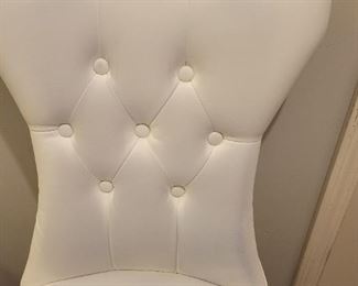 Faux leather armless chair with some discoloration on fabric