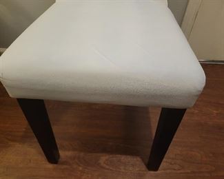 Faux leather armless chair with some discoloration on fabric