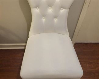 Faux leather armless chair with some discoloration on fabric