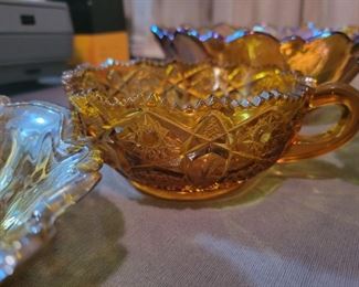 Carnival glass, amber glass, and various candy bowls