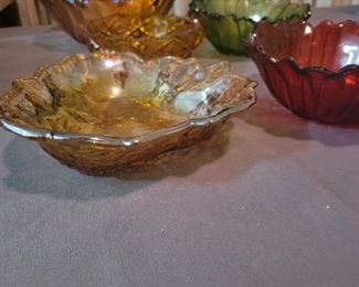 Carnival glass, amber glass, and various candy bowls