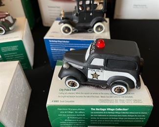 6pc Dept. 56 Christmas in the City Series. City taxi, 1919 Ford model T, city police car, radio city Rockettes, dressed for success, rest ye Merry gentlemen