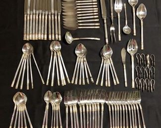 (105) Sterling Silverware: Golden Aegean Weave
By Wallace Silver from 1971-2019 
Total weight- 10lb 14.4 ounces
12-4 Piece Place Settings
12-Soup Spoons
12-Hollow Handle Butter Spreaders, Stainless Blades
12-Iced Tea Spoons
1-Master Butter Hollow Handle, Stainless Blade
2-Serving Tablespoons
1-Pierced Serving Tablespoon
1-Gravy Ladle
1-Cold Meat Fork
1-Butter Knife
1-Sugar Spoon
1-2Pc Carving Set with Guard
12-Napkin Holders