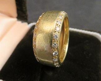 Rows of small diamonds line each edge of this large 18K gold men's wedding band