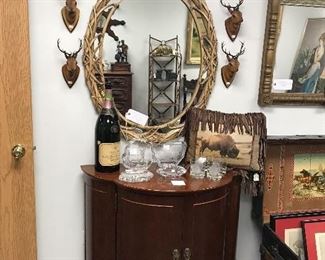 CHERRY LIQUOR CABINET, INSIDE HAS BRASS BARS THAT HOLD LIQUOR BOTTLES, OLD FRENCH CHAMPAGE BOTTLE, CRYSTAL ETCHED HIGH BALL GLASSES WITH BUFFALO'S, GREAT BUFFALO FRINGE PILLOW